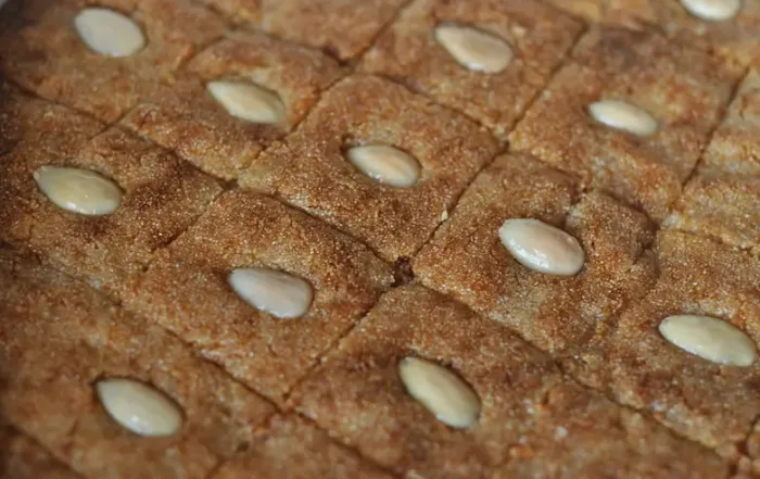 Traditional namoura dessert: a semolina cake (also know as Basbousah) topped with almonds and drizzled with syrup, flavored with rose water or orange blossom water